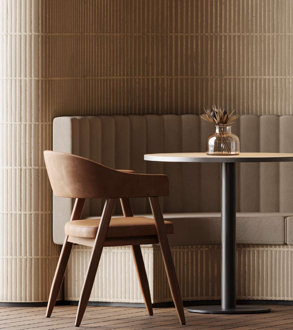 Single chair at a table with a couch in the backdrop