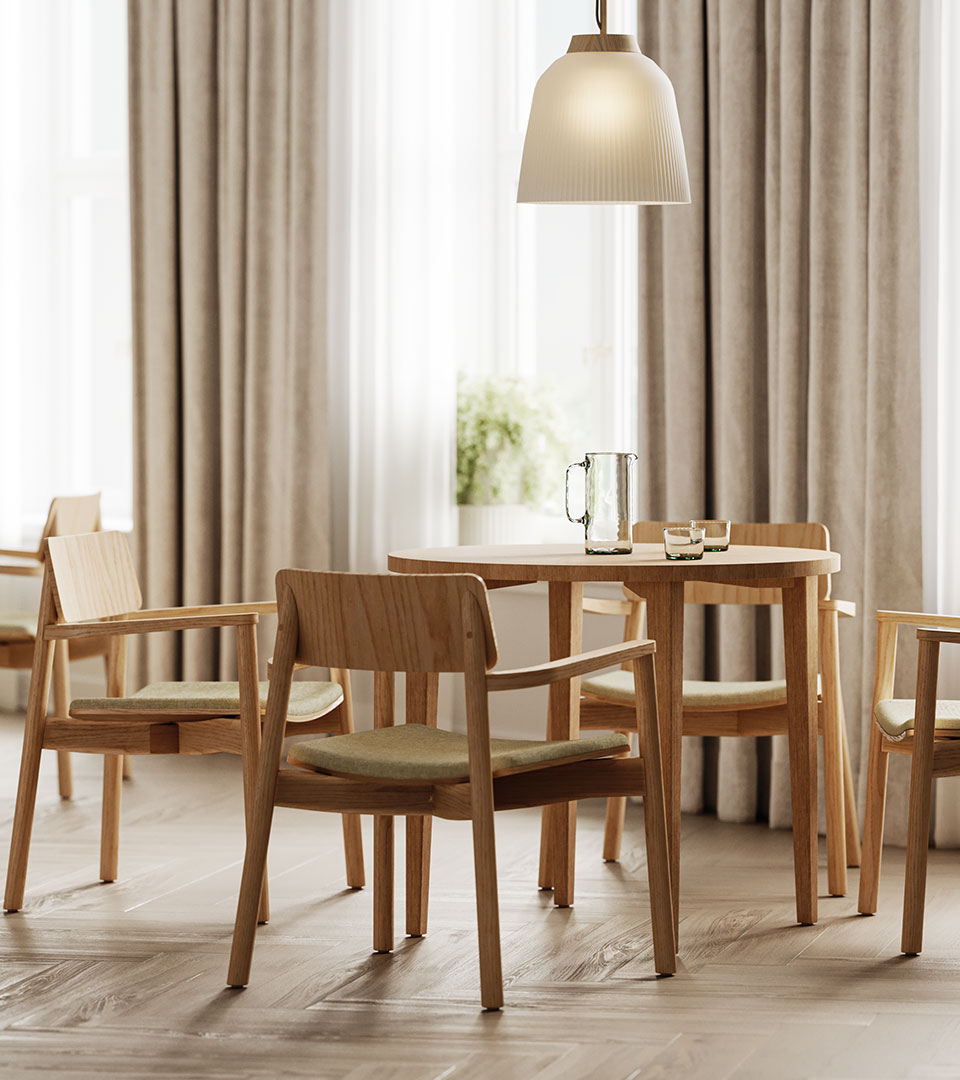 Single chair at a table with a couch in the backdrop